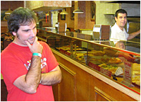 Aaron ordering his first slice of genuine NYC pizza.